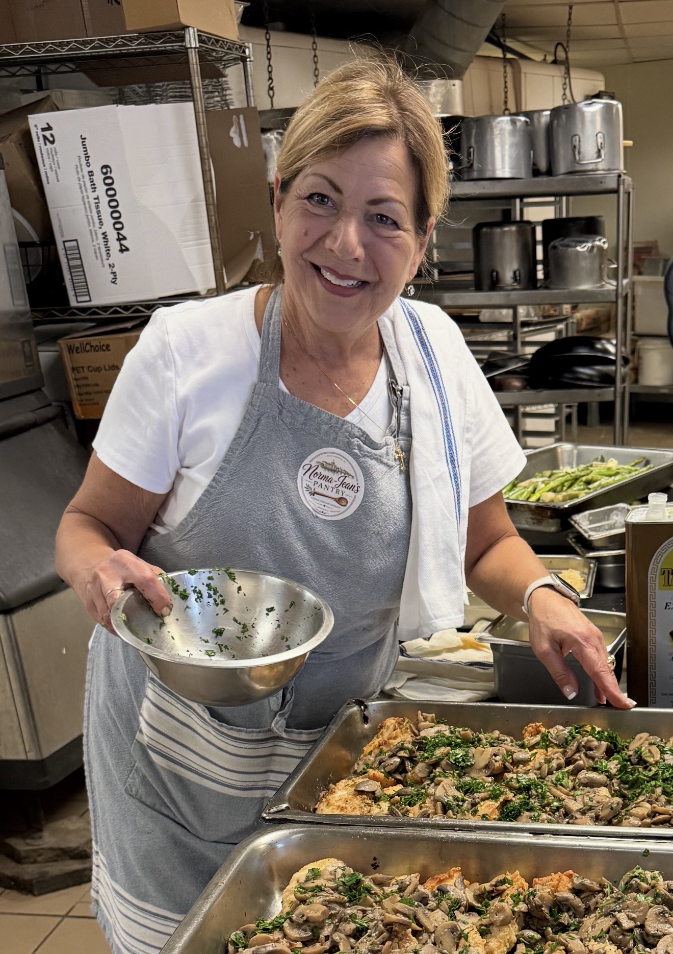 Norma-Jean preparing food with fresh herbs in the pantry